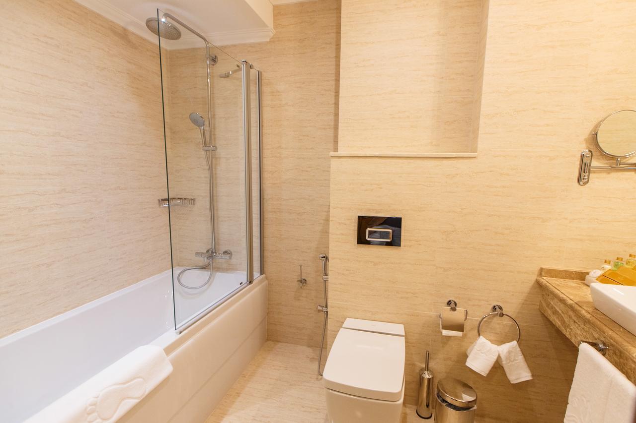 Sultan Palace Hotel Atyrau Exterior photo Bathroom with shower screen
